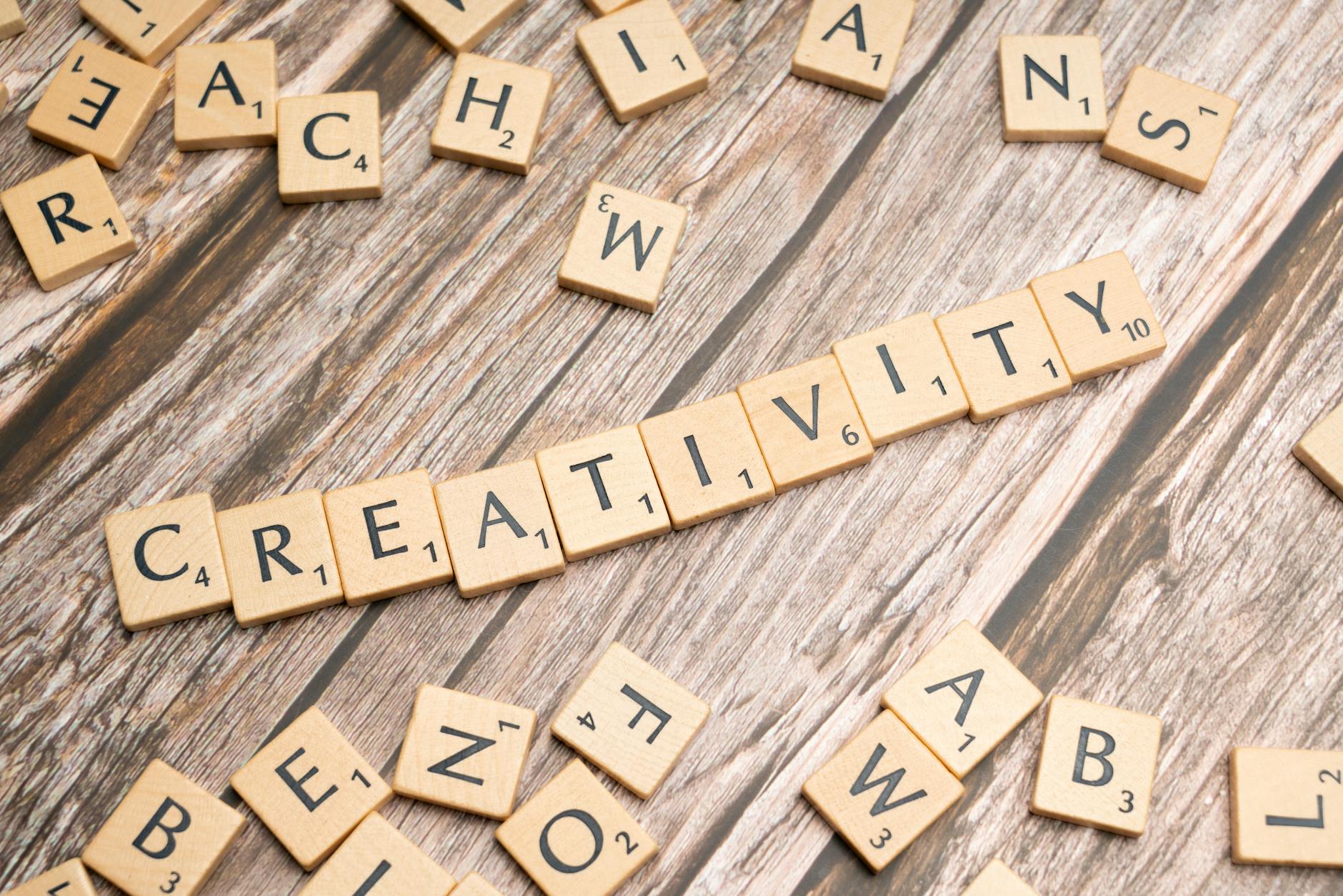 the word creativity spelled out with scrabble tiles