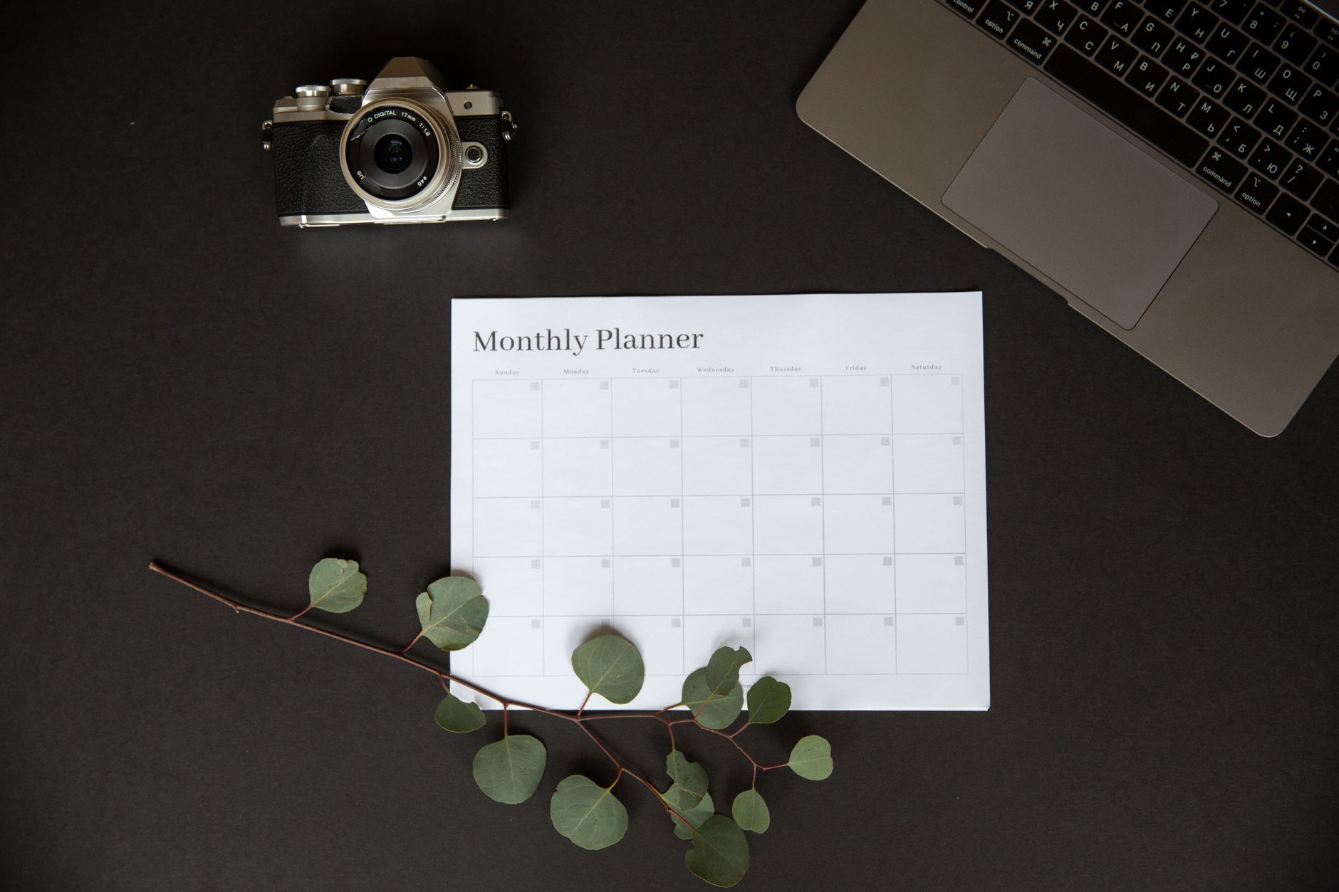 monthly planner sheet laptop camera and a branch