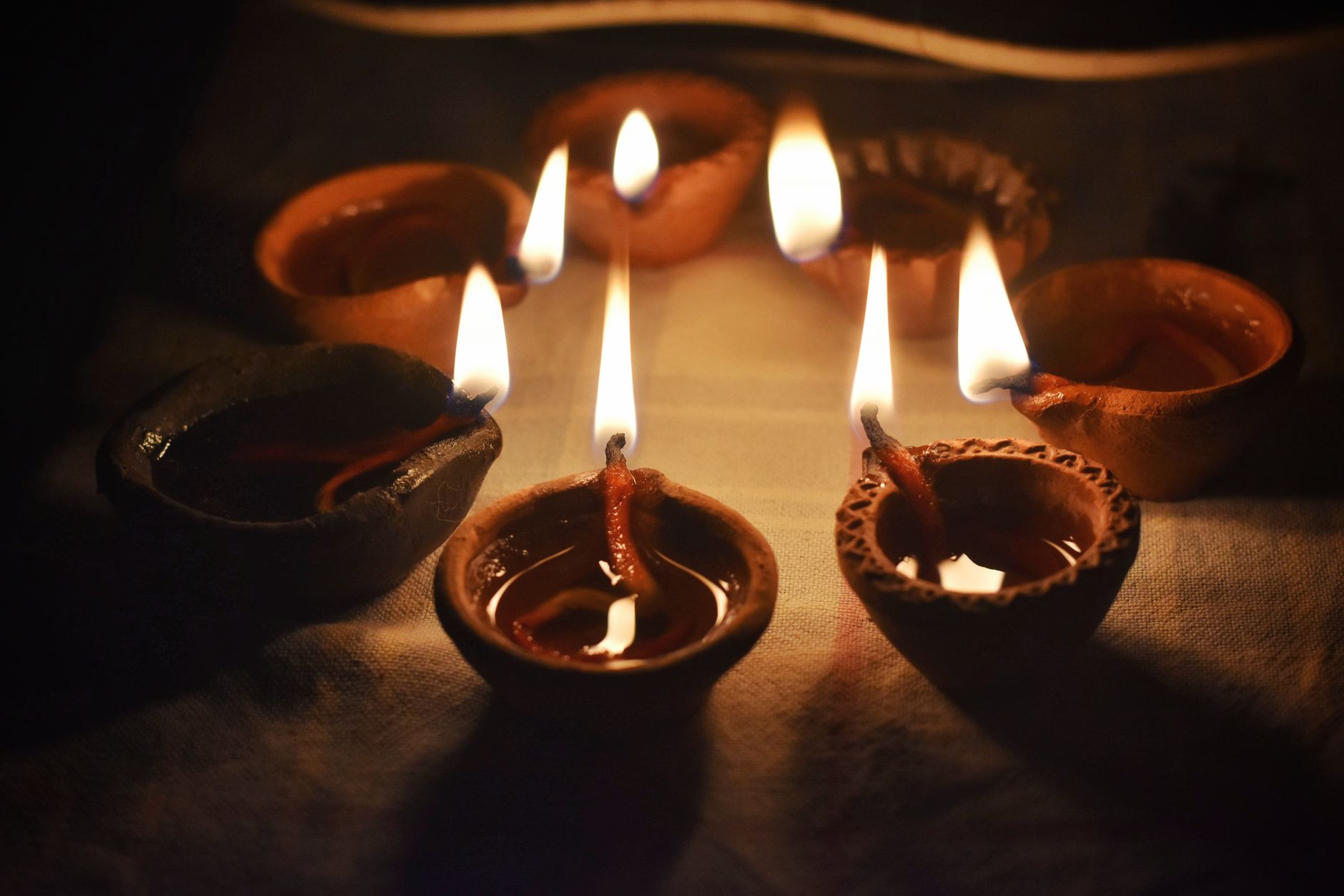 close up shot of lighted candles on the bowls