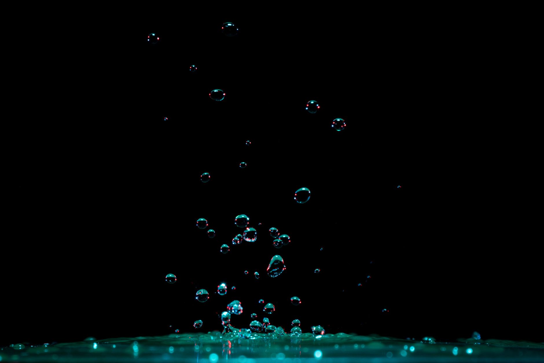 close up of water splashing against black background
