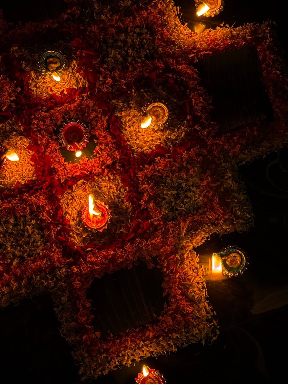 diwali oil lamps arrangement with petals