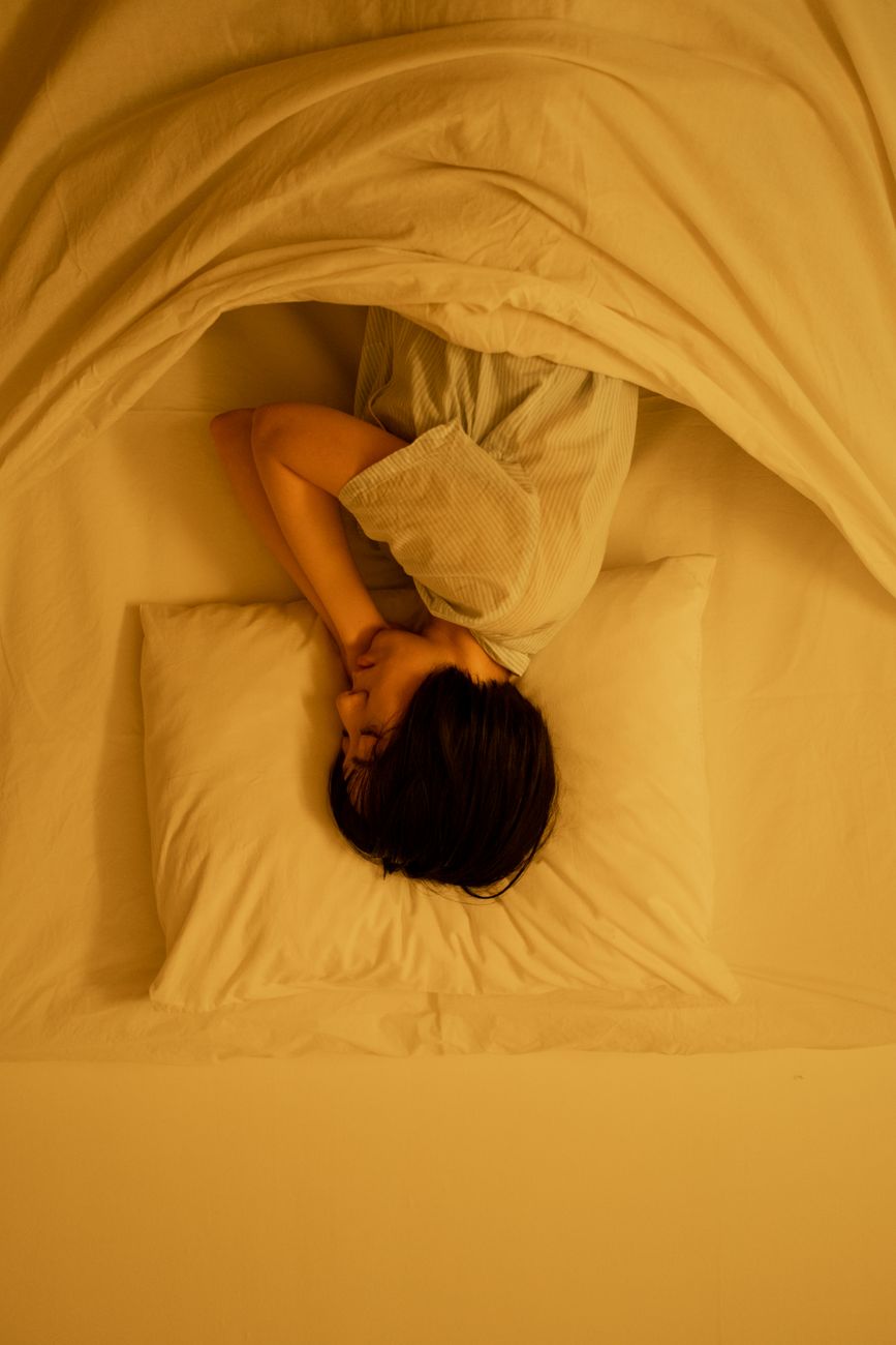 a person sleeping on the bed
