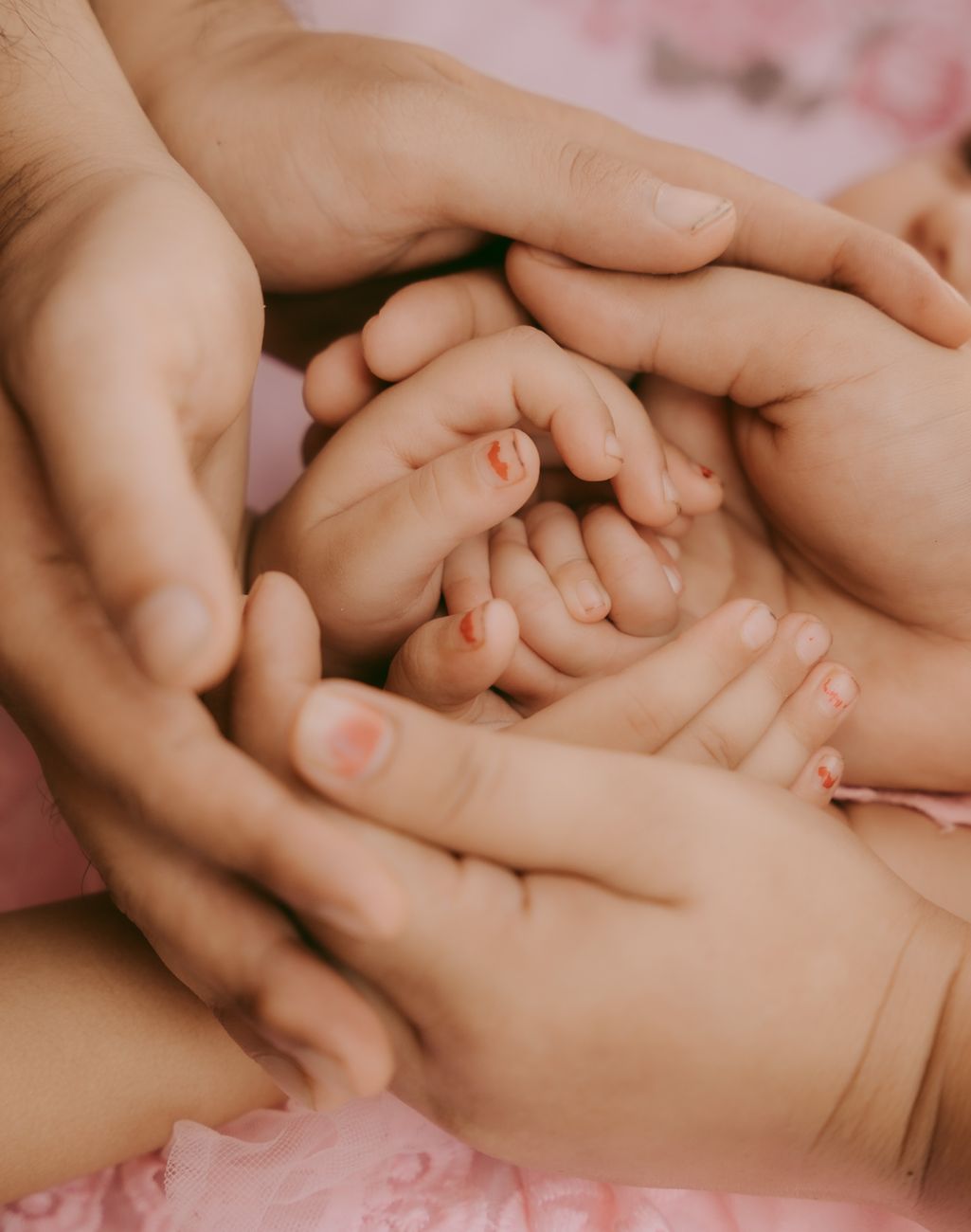 close up of parents and kids hands